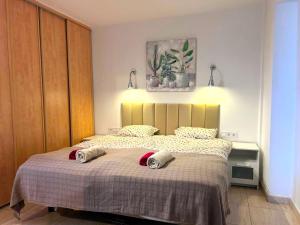 a bedroom with a bed with two towels on it at Comfortable 2 bed in Arguineguín in Arguineguín +12 photos