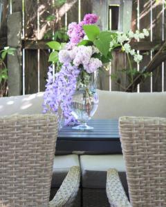 a vase of purple and white flowers on a table at Mary's Country House in Luncaviţa