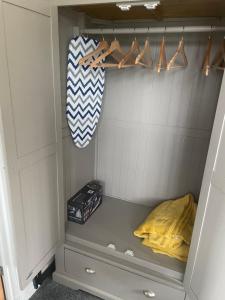 a walk in closet with a bed and hangers at Camaraderie Guest House in York