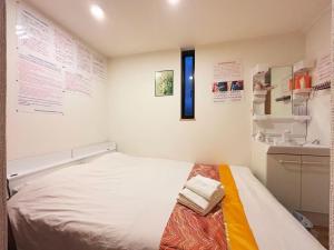 Postel nebo postele na pokoji v ubytování 花乃郷 池袋a