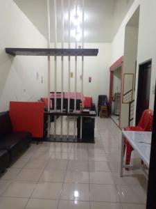 a living room with a couch and a table at Villa gunung mas c6 in Berastagi +1 photo