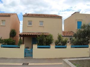a house with a fence in front of it at Mas de Perimont 28 in Fleury