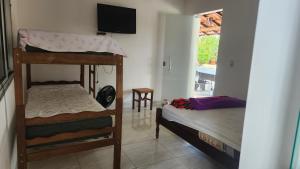 a room with two bunk beds and a flat screen tv at sitiolosbragas in Caetanópolis +28 photos