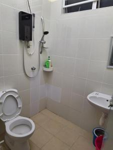 a bathroom with a shower and a toilet and a sink at BC homestay at Alma Indah in Bukit Mertajam