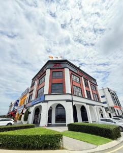 a large building with cars parked in front of it at ZONE Hotels, Eco Grandeur in Bandar Puncak Alam
