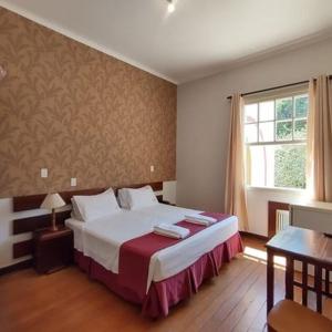 เตียงในห้องที่ Avenida Charme Hotel