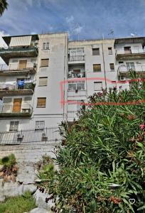 a white apartment building with a red stripe on it at Casa di Angela in Syracuse