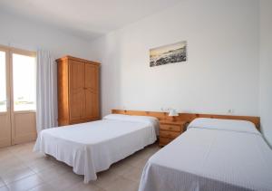 Posteľ alebo postele v izbe v ubytovaní Hostal Mayans