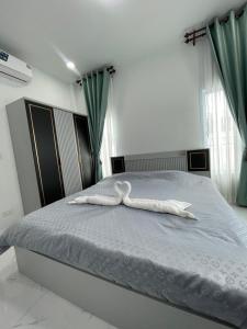 Giường trong phòng chung tại บ้านพักขอนแก่น บ้านมั่งมี ใจกลางเมือง +15 ảnh