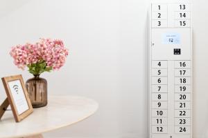 a calendar with a vase of flowers on a table at Casa Jazmin by Blossom Hotels in Granada