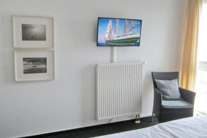 Televiisor ja/või meelelahutuskeskus majutusasutuses NordseeResort Friesland NordseeResort Friesland 51-2-S