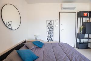 a bedroom with a large bed and a mirror at Le Ninfee in Zola Predosa +44 photos