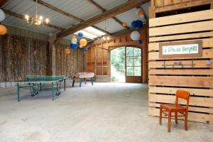 a room with two ping pong tables and a ping pong ball at Gite rural de Bergnes à l'ombre des grands pins in Campagne-sur-Aude