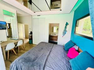 a bedroom with a large bed with a blue wall at Studio chic & champêtre in Aussonne