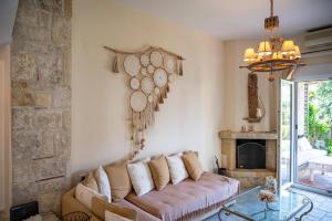a living room with a couch and a fireplace at Emily's Luxury Suites in Pefkochori