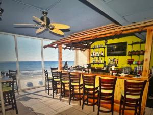 a restaurant with a bar with a view of the ocean at Panama City Beach, Beach Front Condo 207 in Panama City Beach