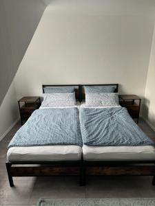 a bed with two pillows on it in a room at Komplett neu renovierte Wohnung! in Hannover