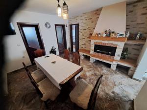 a living room with a table and a fireplace at Casa Doi Crai in Zărneşti