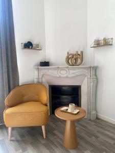 a living room with a chair and a coffee table at DOMITYS - Cœur de Loire in Tours