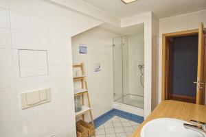 a bathroom with a sink and a shower at Ferienwohnung mit traumhaftem Meerblick - Haus am Meer FeWo 12 in Lohme +27 photos