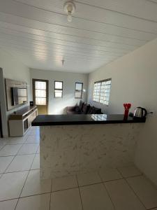 a kitchen with a counter top in a room at Sua casa em Dourados in Dourados +3 photos