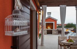 a bird cage on the wall of a house at Villas Vilanija in Umag