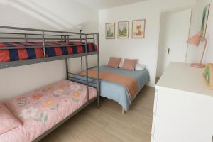 a bedroom with two bunk beds and a desk at Magic Disney Terrasse - 2 ch - parking gratuit - 5 min parc in Serris
