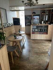 a coffee shop with two tables and a counter at BARLOS HOTEL in Uruguaiana +8 photos