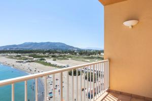 a balcony with a view of a beach and the ocean at Sol Guadalmar in Málaga
