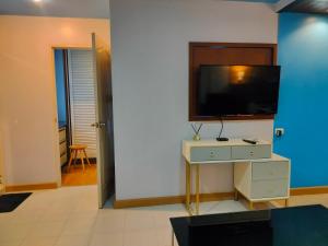 a living room with a tv on a wall at ห้องพักสวยแสนสบาย in Ban Chek +5 photos