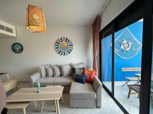 a living room with a couch and a table at Ayla Beach Apartment Azure 1522 Families only in Aqaba