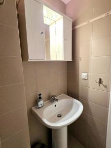 a bathroom with a sink and a mirror at Villa Sea View in Chios
