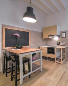 a kitchen with a table and a blackboard on the wall at Apartments Florence - Rosa piccolo in Florence