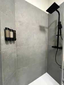 a bathroom with a shower with a shower head at Olive Rooms in Zadar