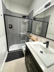 a bathroom with a shower and a sink and a toilet at Olive Rooms in Zadar