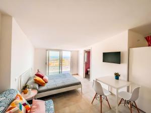 a living room with a bed and a table at CILENTO BEACH house VISTA MARE in San Nicola