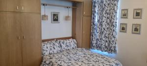 a small bedroom with a bed and a curtain at 223 Websters land - stunning castle view in Edinburgh