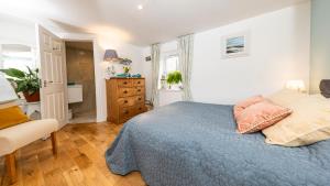 a bedroom with a blue bed and a dresser at City Centre Haven in Perth