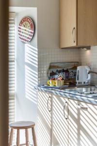 a kitchen with a counter and a stool in a kitchen at City Centre Haven in Perth