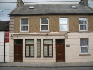 an old building with a sign for a university at Cooraclare apartment in Cuar an Chláir