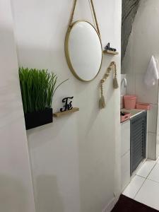 a bathroom with a mirror and a sink at Kitnet compacta in Salvador +18 photos