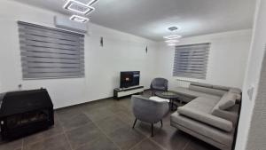 a living room with a couch and a television at Nuko's family in Nikšić