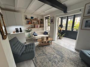 a living room with a couch and a table at L'Attrape Coeur in La Baule