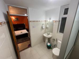 a small bathroom with a toilet and a sink at Dream Ladakh Guest House in Leh