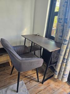 a wooden table with a chair and a wooden desk at 55 New Street, Makhanda in Grahamstown