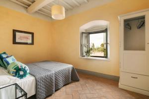 a bedroom with a bed and a window at Le Dimore di Terrarossa Argentario in Porto Ercole