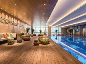 a hotel lobby with a swimming pool and a pool at NOVOTEL Jinji Lake Suzhou SIP in Suzhou