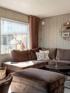 a living room with a couch and a table at Lindvallen Ski Resort - Sauna - 10 Guests in Sälen