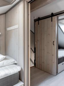 a room with two bunk beds and a sliding door at Lindvallen Ski Resort - Sauna - 10 Guests in Sälen