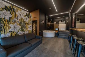 a living room with a couch and a bathroom at Casa Per Bacco in Vallecrosia